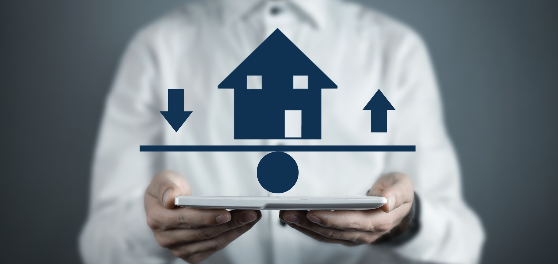 Man showing house with upward and downward arrows on the scales.